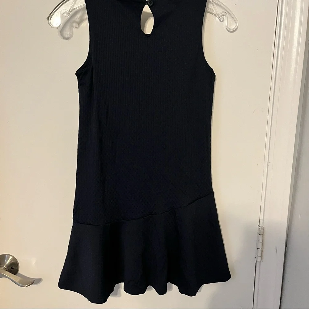 Chaps girls, navy blue jumper flounce hemline and a keyhole closure Size medium.